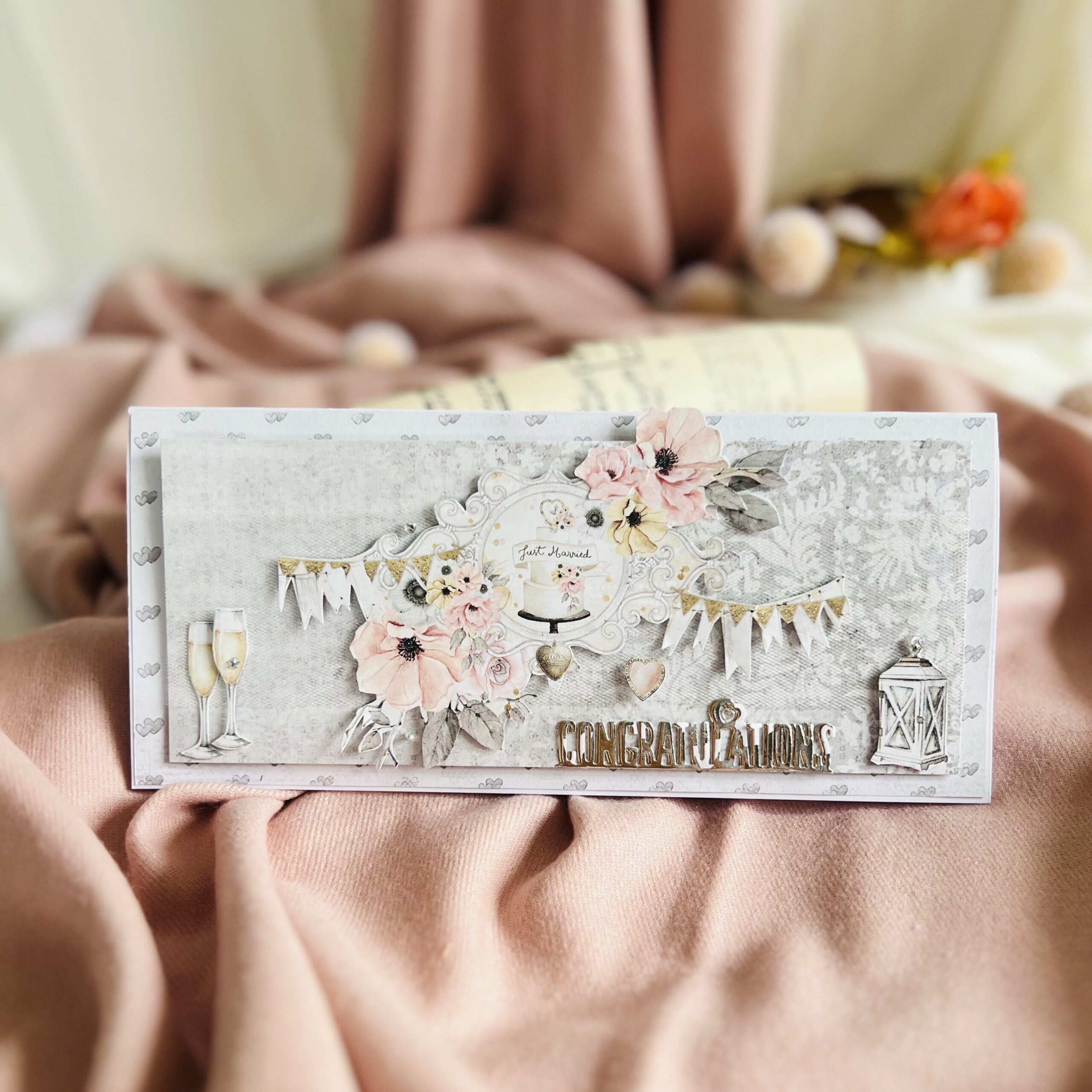 Handmade cream and gold wedding card with champage glasses,paper flowers,and Just Married inspiration.