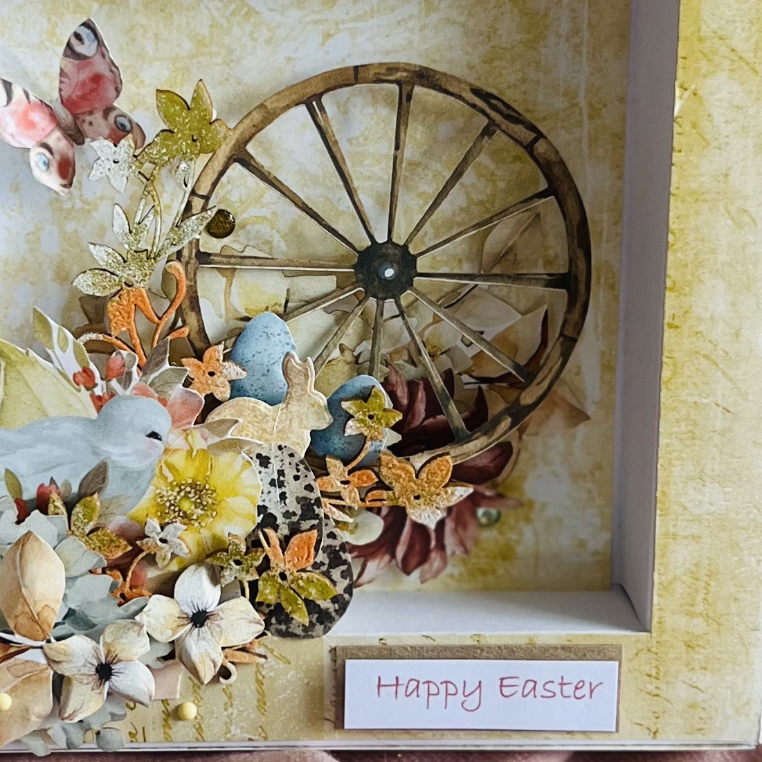 An agricultural wheel decorated with flowers and hidden eggs inside them